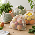 Organic cotton mesh produce bags filled with fresh vegetables and fruit